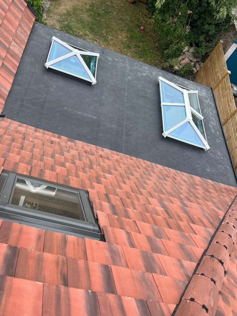 This is a photo taken from the roof ridge looking down a tiled pitched roof on to a flat roof. Works carried out by MCM Roofing Repairs Thatcham