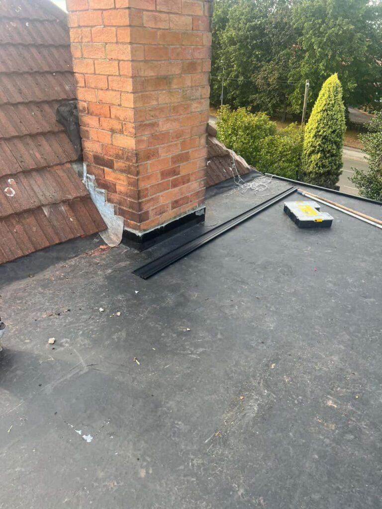 This is a photo of a flat roof which has just been repaired, there is also a chimney stack and some leadwork has also been dressed. Works carried out by MCM Roofing Repairs Thatcham