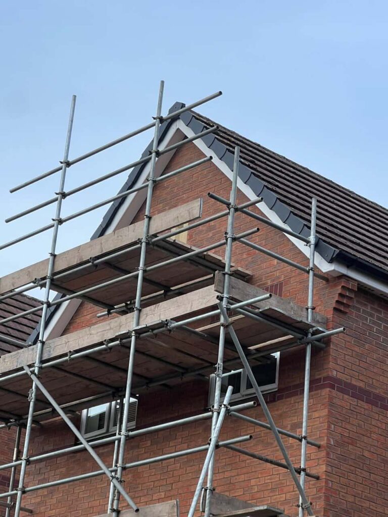 This is a photo of a roof which has just been repaired. There is a scaffold located at the gable end for access onto the roof. Works carried out by MCM Roofing Repairs Thatcham